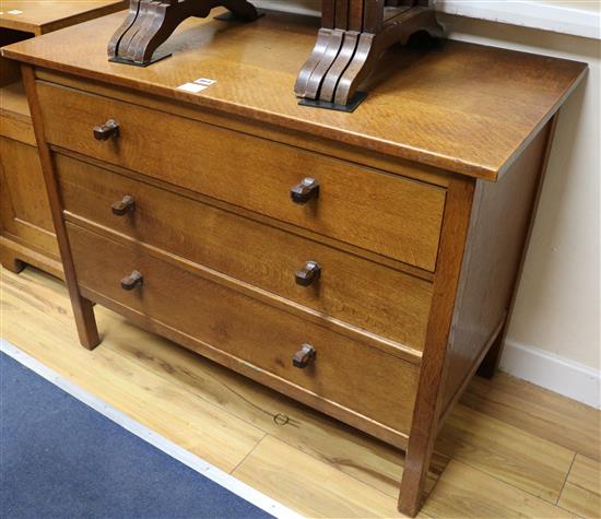 A pair of Gordon Russell oak chests, fitted with three long drawers W.99cm